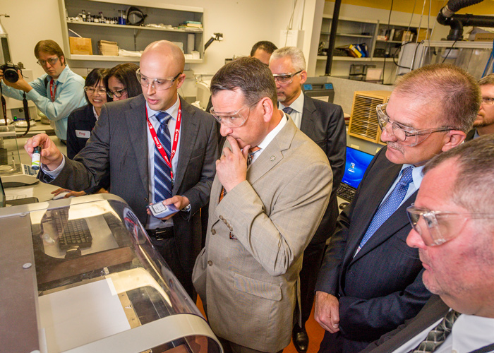 Senior research scientist at Xerox Research Centre of Canada, demonstrates the printing of electronic circuitry using a Xerox ink composed of metal nanoparticles to Minister of State Rickford